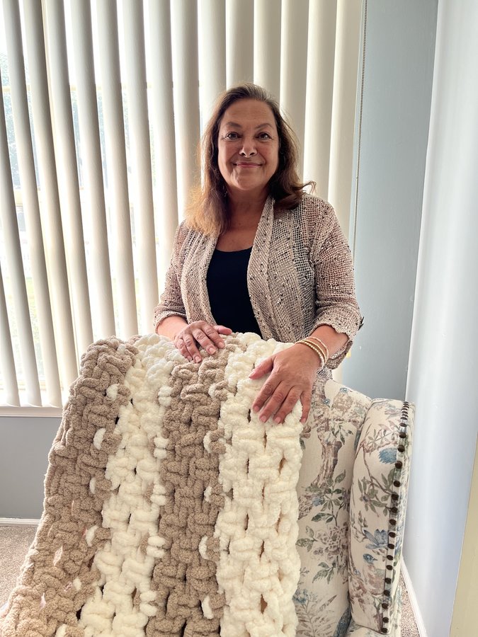 Barbara, the maker behind Hearth & Knot, with one of her hand-knotted chenille blankets